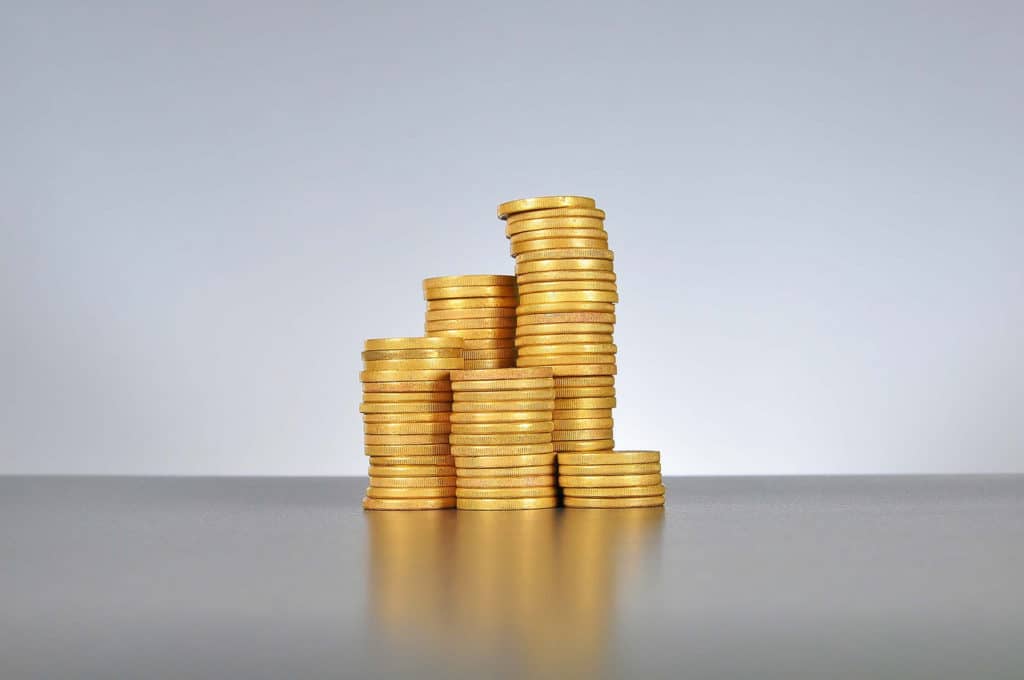 gold coins stacked up in several piles