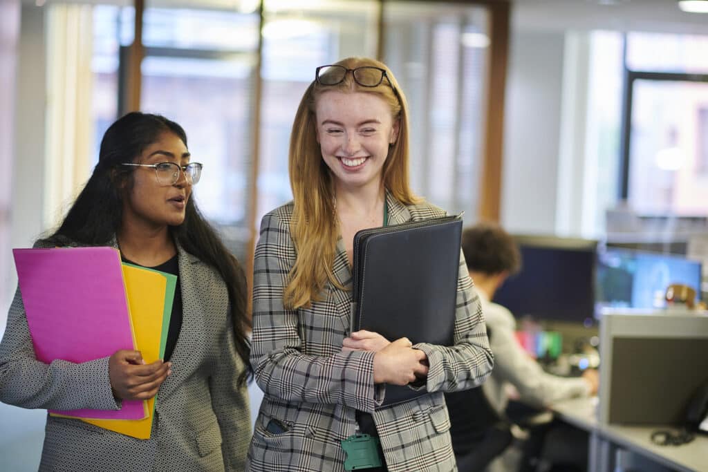 happy young paralegals walking through the office
