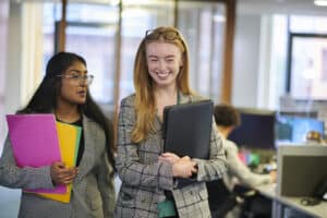 happy young paralegals walking through the office